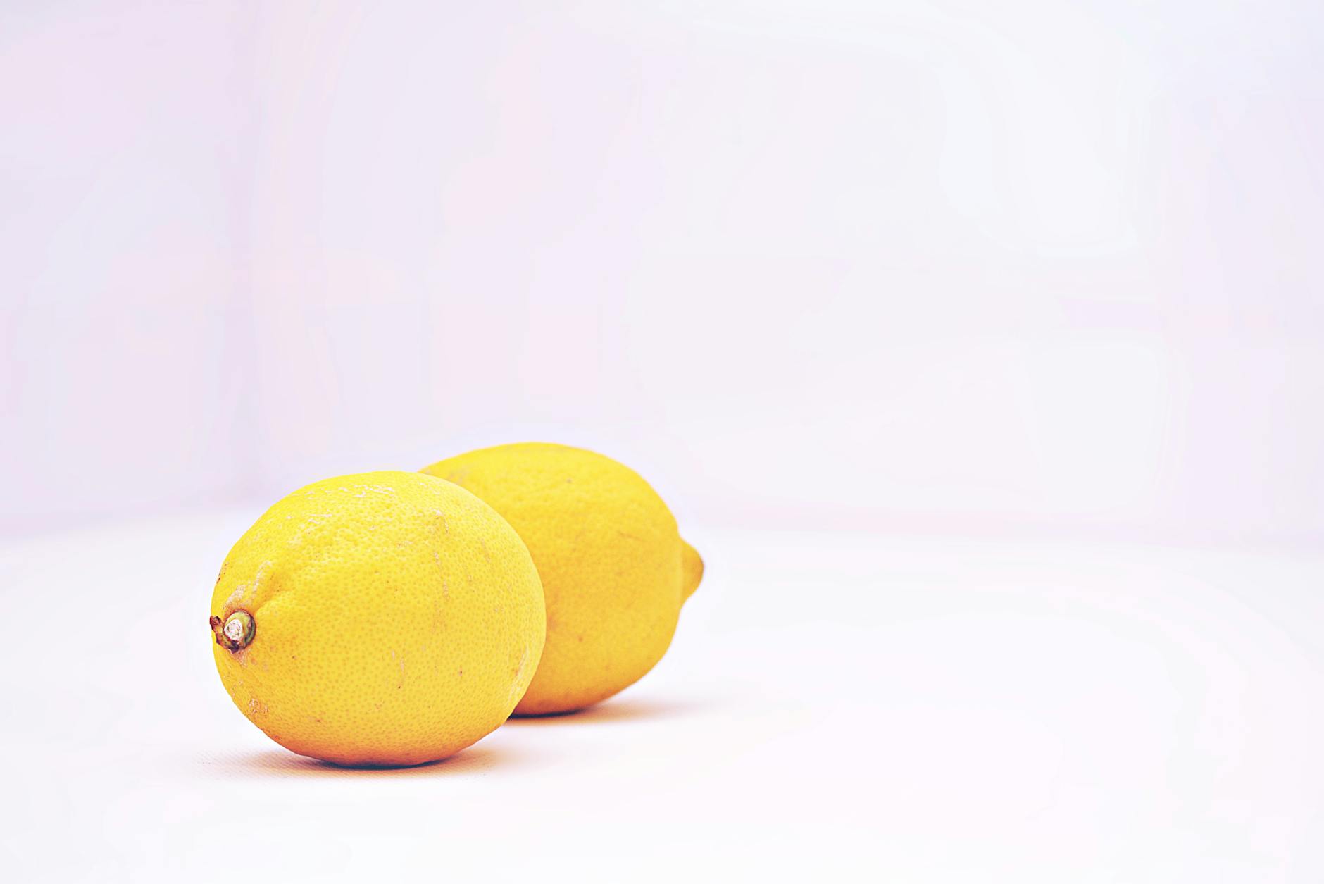 Bright fresh lemons on a clean white background, symbolizing clarity and straightforward intimacy