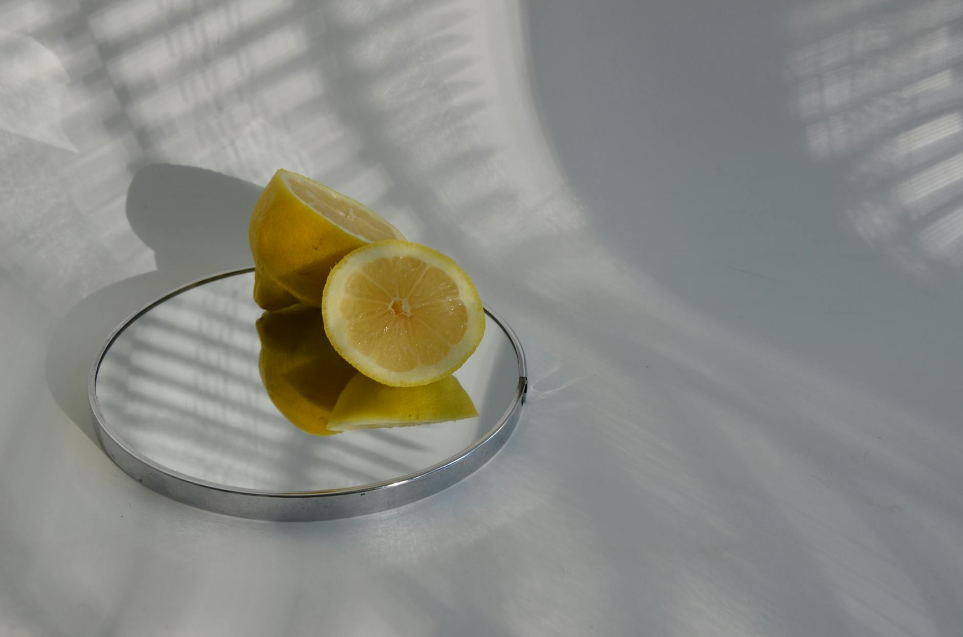 Vivid fresh lemons on a yellow background in bright studio light